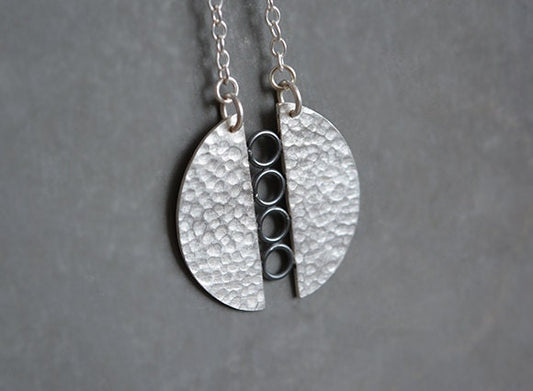 Sterling silver textured circle pendant necklace.