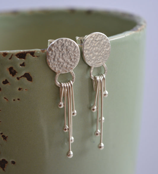 Sterling silver dangle textured disc earrings.