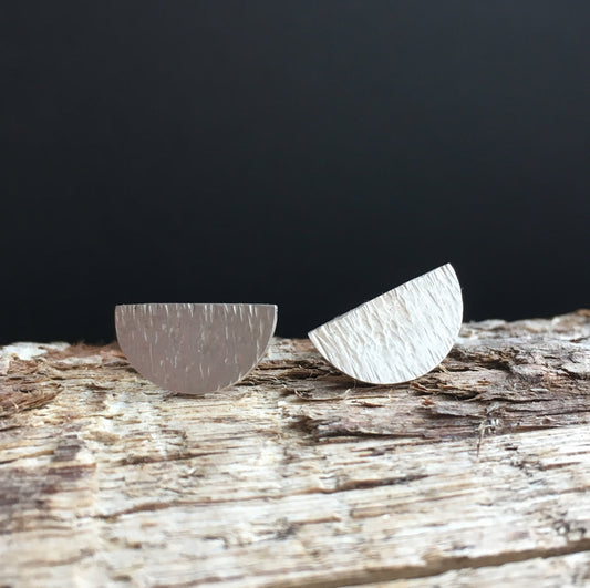 Hammered semicircle sterling silver stud earrings.