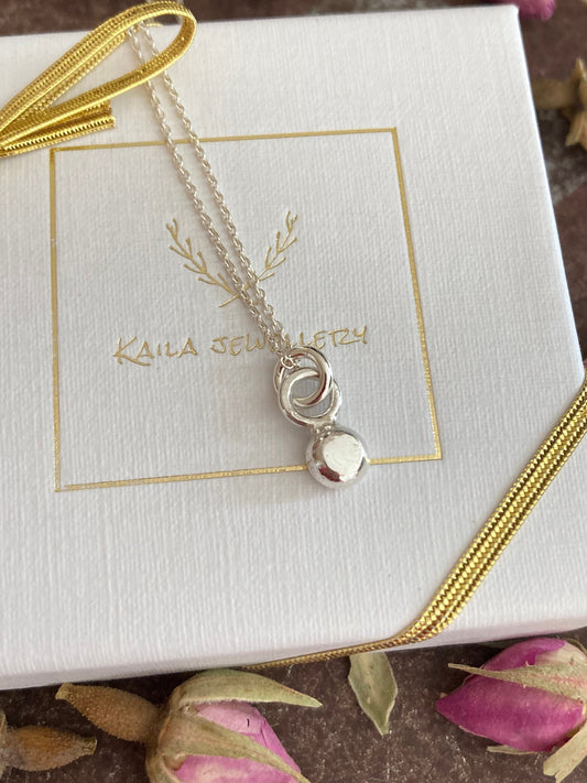 Tiny solid sterling silver pebble charm necklace pendant.