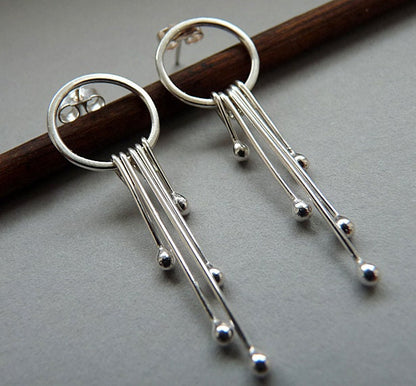 Long sterling silver circle stud earrings.